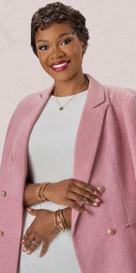 Tee Adewunmi smiling in a blush blazer